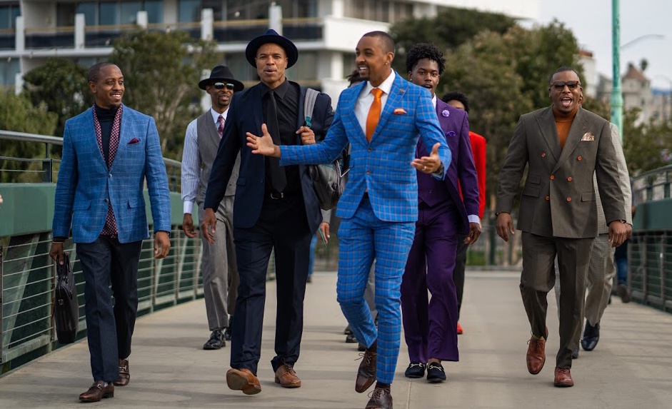 Photo of men walking on bridge