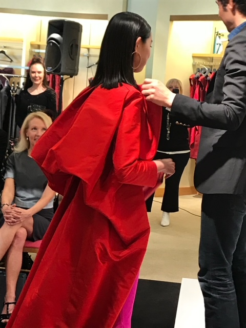 Model wearing red dress at fashion show