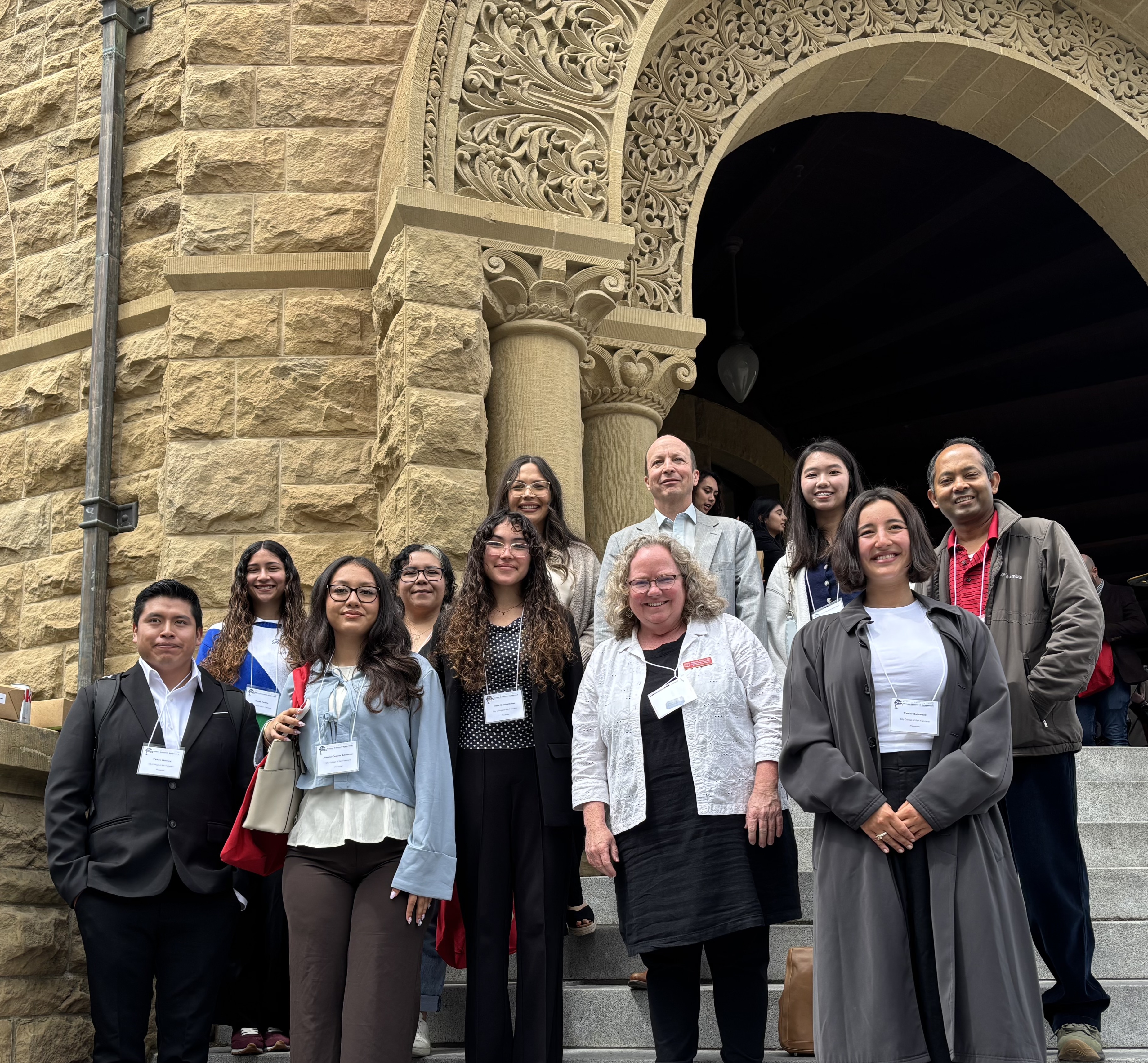 CCSF faculty and students at the Bay Honors Research Symposium standing on the steps of History Corner at Stanford University in May 2026.