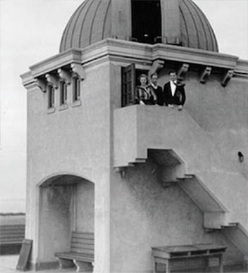 Three people on stairs of observatory