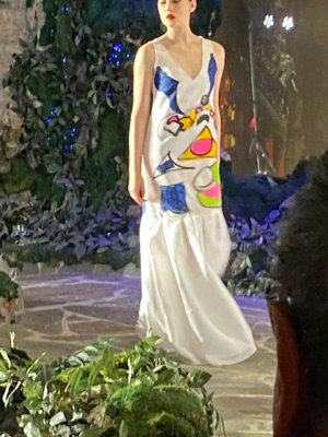 Model in white dress with colorful design