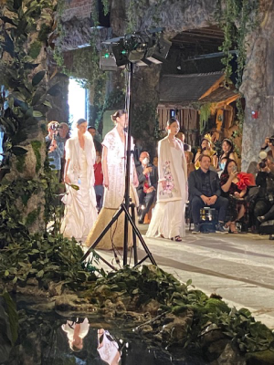 Three models in white dresses