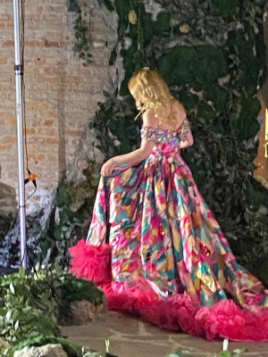 Model in colorful, frilly dress