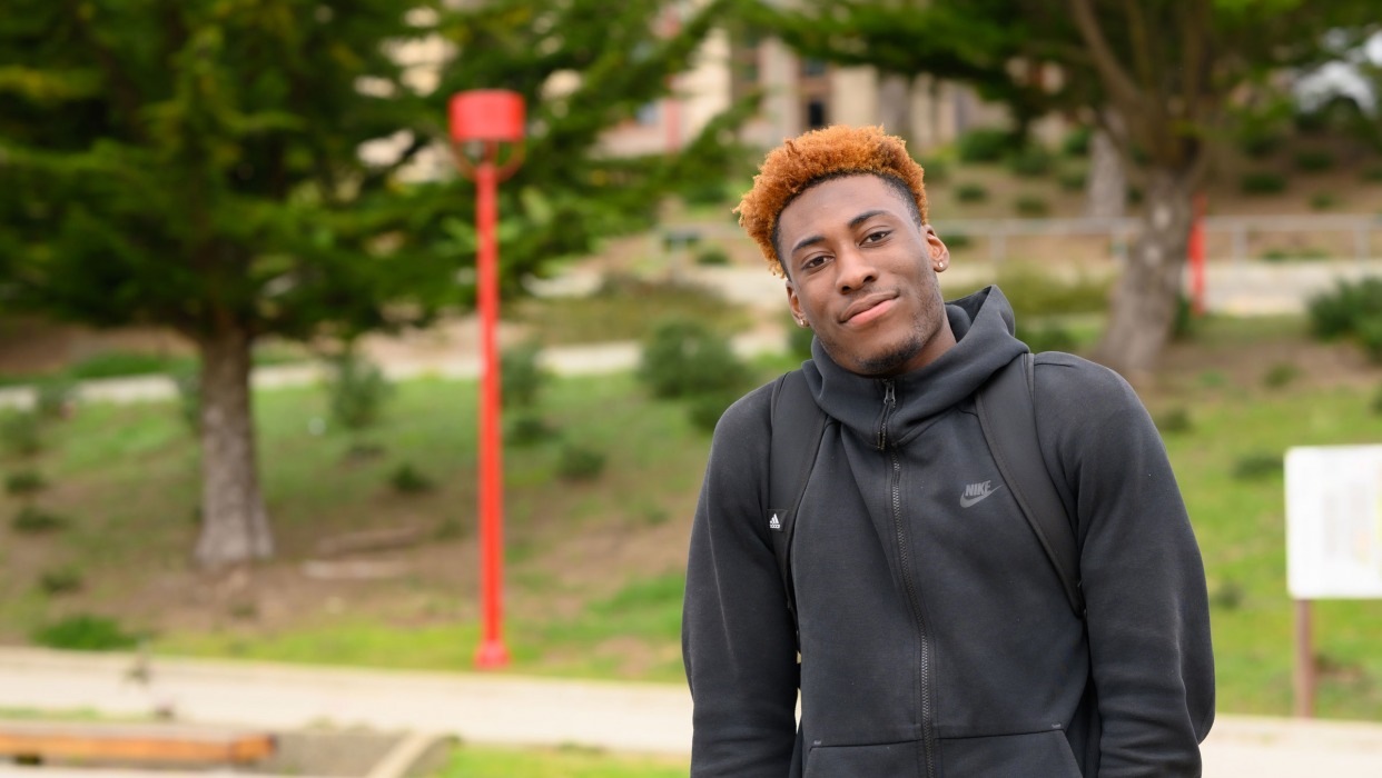 Student stands in front of Ocean Campus