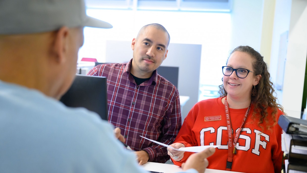 CCSF Staff members help a student