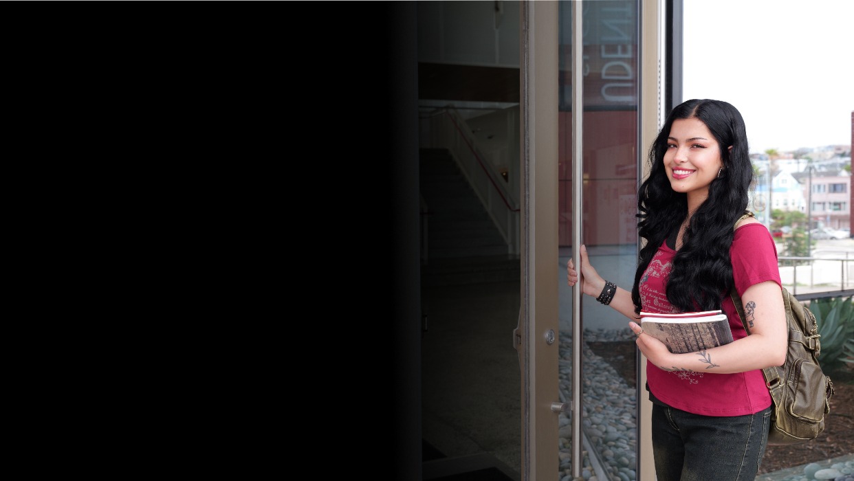 Student holding door