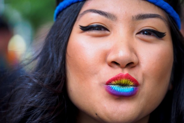 Woman with rainbow painted lips