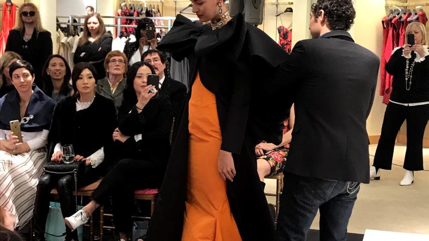 Model in black and orange dress
