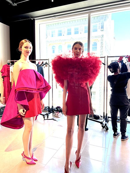 Two models in pink dresses