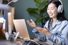 Student studying at computer and smiling